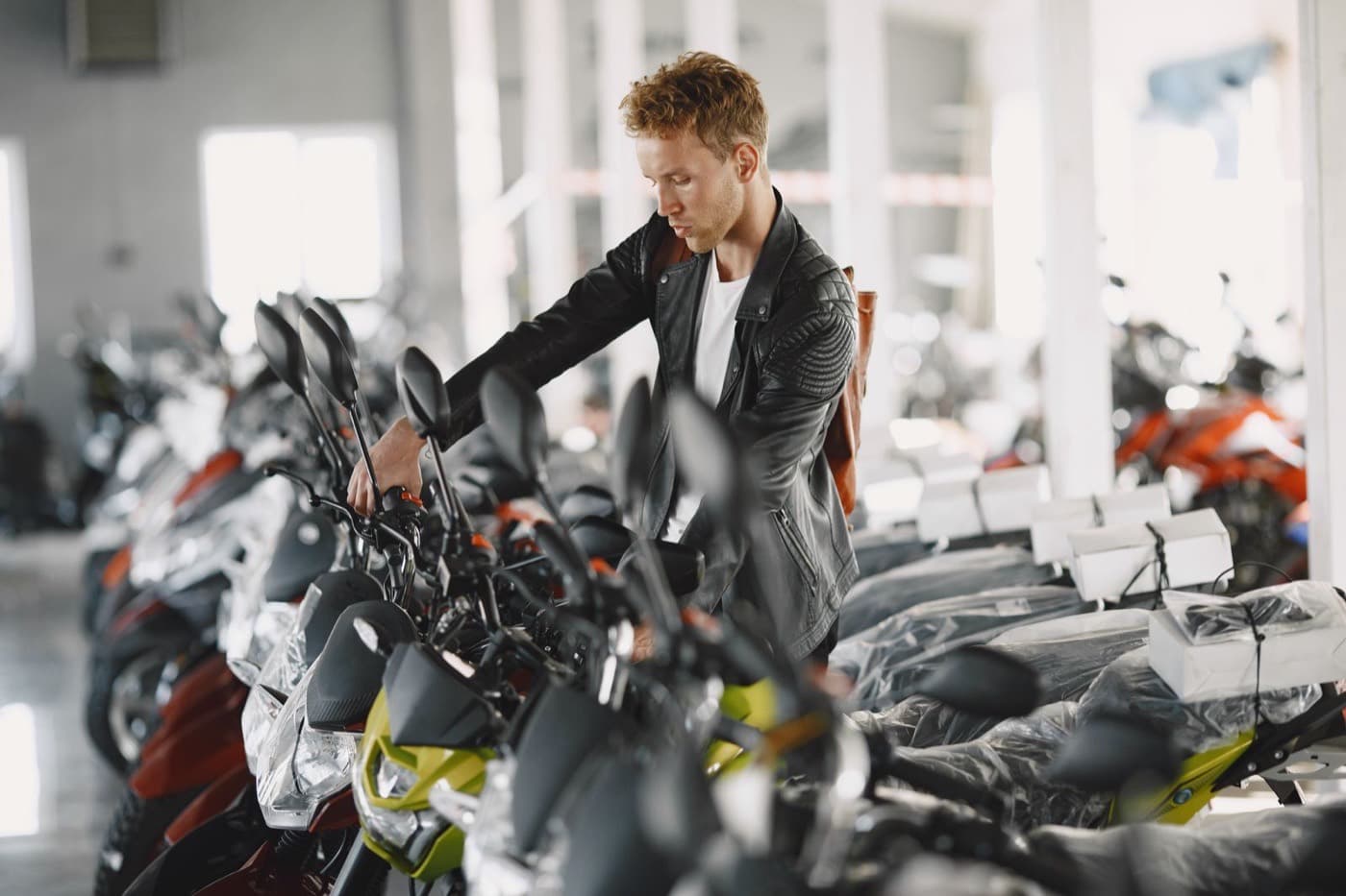 Motorcycles lined up inside a bright, modern dealership showroom
